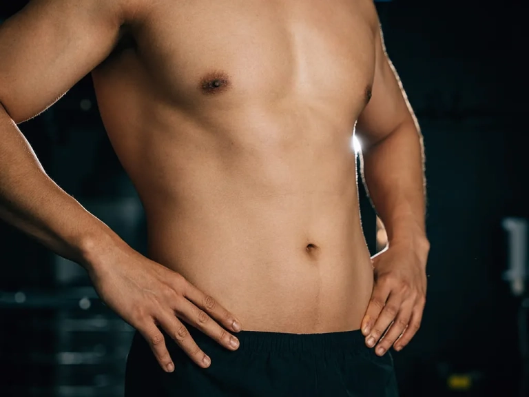 Image of a torso of a fit man with his short off for Emsculpt New at The Hughes Center in Cherry Hill